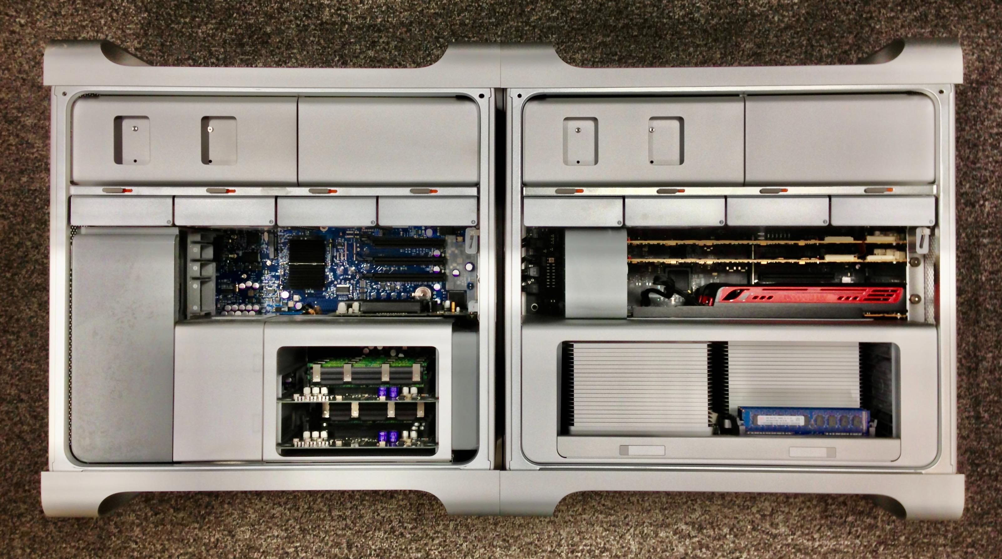 Photograph of two Mac Pro models side-by-side on the floor with the side panels removed. The one on the left is an older "Early 2009" model with a huge portion of the case given up to the removable DRAM boards. The newer "Mid 2010" model on the right has a much larger and simpler lower section combining CPUs and DRAM into one removable module.